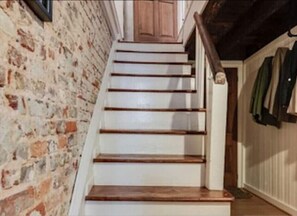 A staircase with wooden steps and a white wall on one side. - 18th Cent. Charm in Historic Downtown Annapolis (Annapolis)