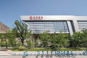 A modern building with a sign that reads 'North Wing Hotel.' - Xilai Hotel (Yueqing)
