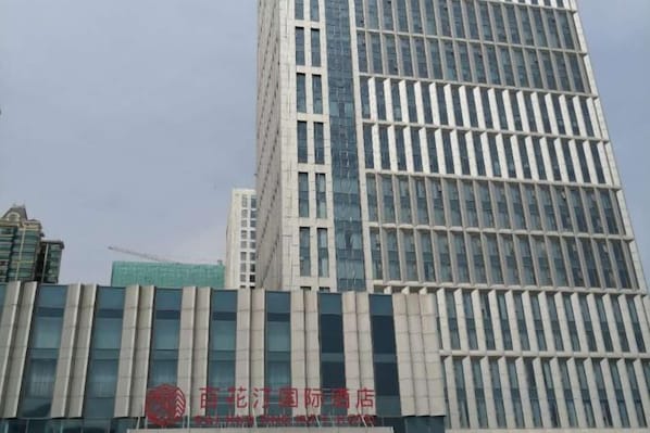 A modern building with a prominent vertical design and a large glass facade.