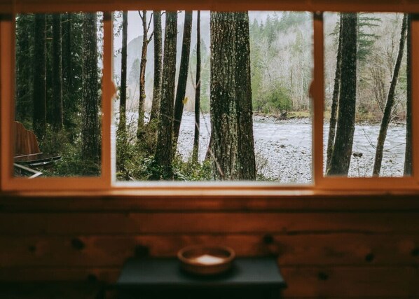 A window with a view of a forest and a river. - Persis River View-Outdoor shower/Sauna/Cold plunge (Sultan)