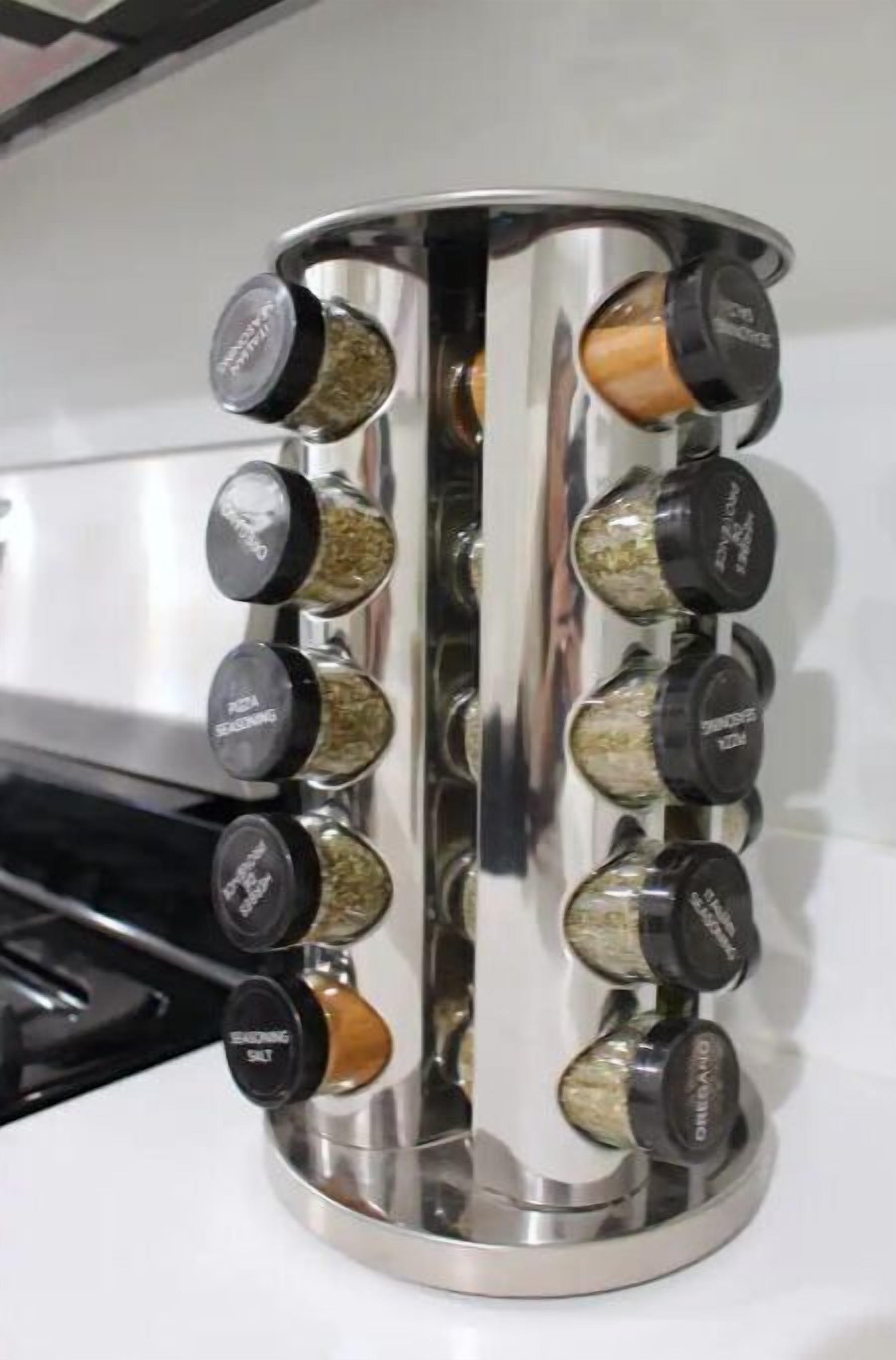 A stainless steel spice rack with multiple spice jars.
