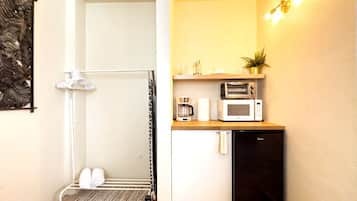 A compact kitchen with a microwave, toaster, and coffee maker.