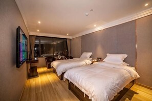 A hotel room with two beds, a TV, a desk, and a chair. - Baba Boutique Hotel (Xiamen)