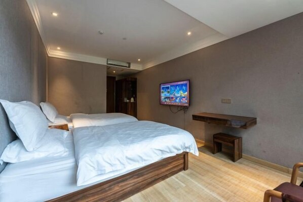 A bedroom with a bed, a TV mounted on the wall, a wooden bench, and a small table. - Baba Boutique Hotel (Xiamen)