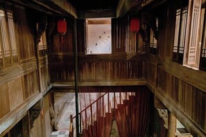 A multi-level wooden structure with a staircase, wooden railings, and traditional windows. - Yanshe Inn (Huangshan City)