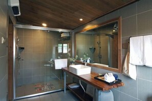 A modern bathroom with a glass shower enclosure, a large mirror, and a wooden vanity. - Yanshe Inn (Huangshan City)