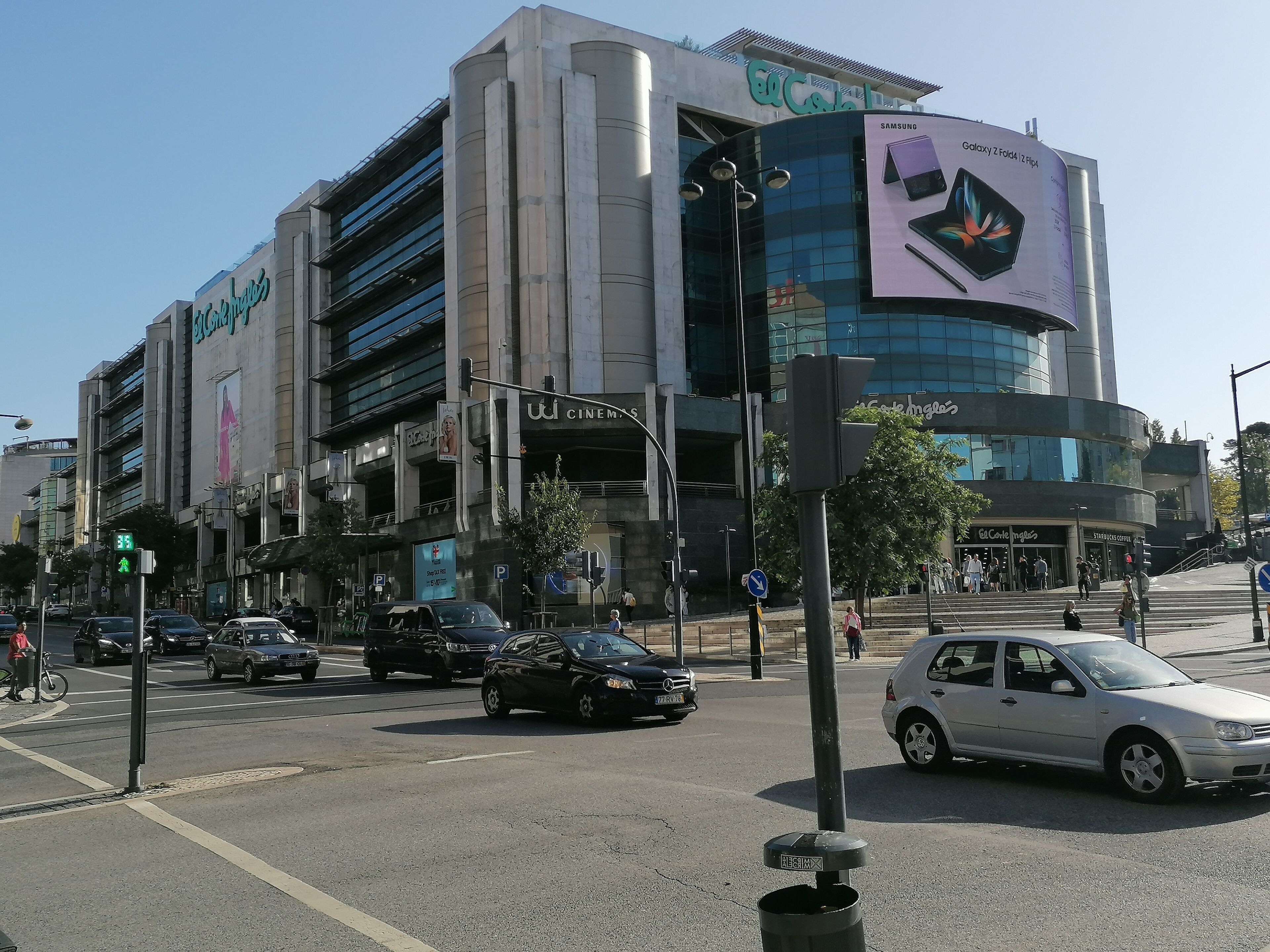 A modern building with multiple floors, featuring a prominent Samsung advertisement on the side.