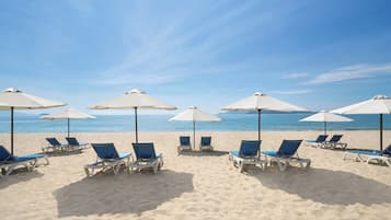On the beach, sun loungers, beach umbrellas, beach towels