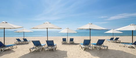 On the beach, sun-loungers, beach umbrellas, beach towels