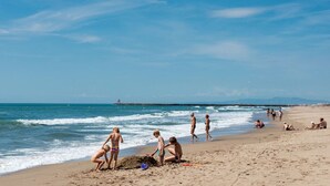 A beach with people engaging in various activities like playing and walking. - Mobil-home VIP | Clim & Plancha | Plage à 700 m (Vendres)