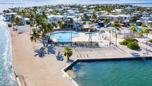 A coastal resort with multiple villas, a central pool area, and a beach. - Venture Out Million Dollar Ocean View (Cudjoe Key)