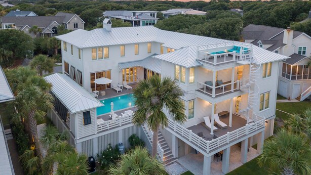A multi-story house with a pool, multiple balconies, and a well-maintained lawn. - Brand New Luxury 6 bedrooms, 7.5 bathrooms, pool, spa, elevator, ocean views (Isle Of Palms)