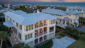A two-story house with a balcony, a driveway, and a view of the ocean. - Brand New Luxury 6 bedrooms, 7.5 bathrooms, pool, spa, elevator, ocean views (Isle Of Palms)