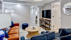 Una sala de estar moderna con un sofá, una mesa de centro y un televisor.