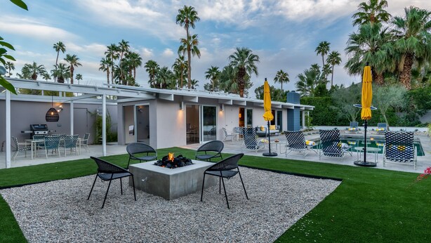 A modern outdoor patio with a fire pit, seating, and a pool area. - MCM Poolside Paradise - Mountain Views & Total Privacy (Palm Springs)