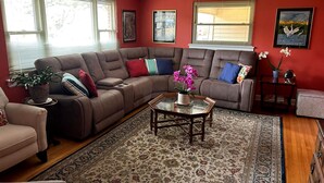 A living room with a sectional sofa, a coffee table, and a rug.