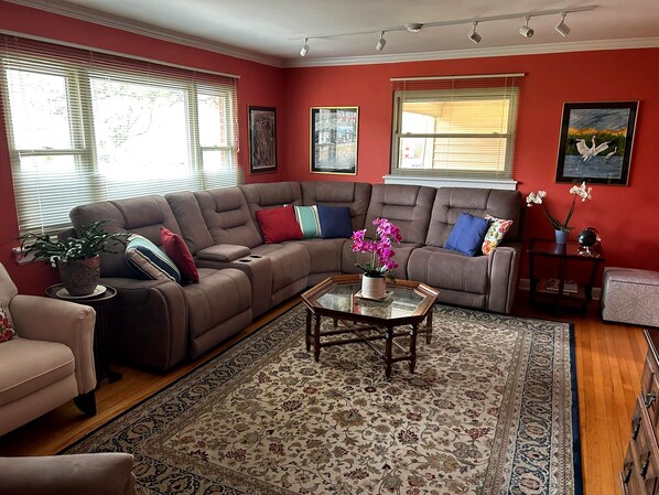 A living room with a sectional sofa, a coffee table, and a rug.