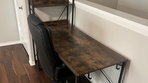 A corner office with a dark wooden desk, black office chair, and metal frame. - Scottsdale Couples Getaway| Pool & Hot Tub| Scenic (Scottsdale)