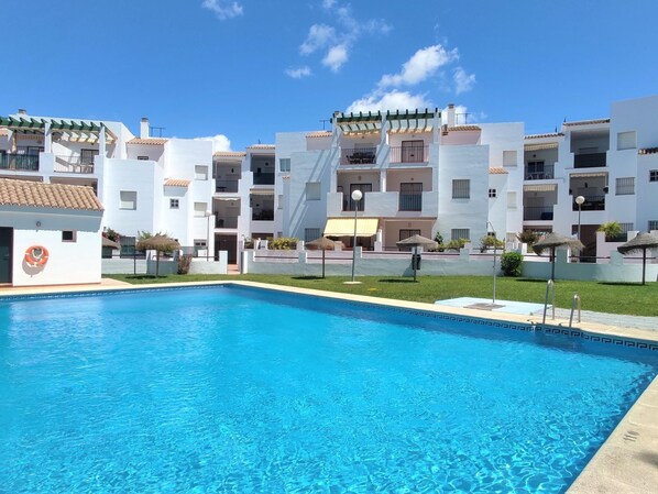Enjoy a refreshing swim in the central pool surrounded by a well-maintained deck.
