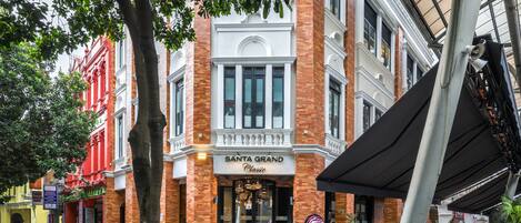 A historic building with a classic facade, a prominent entrance, and a covered outdoor area.