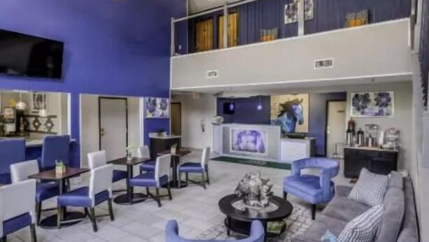 A spacious lobby with a high ceiling, multiple seating areas, and a television screen. - Relaxing Unit Near Attractions in GuestHouse Lexington, Parking! (Lexington)