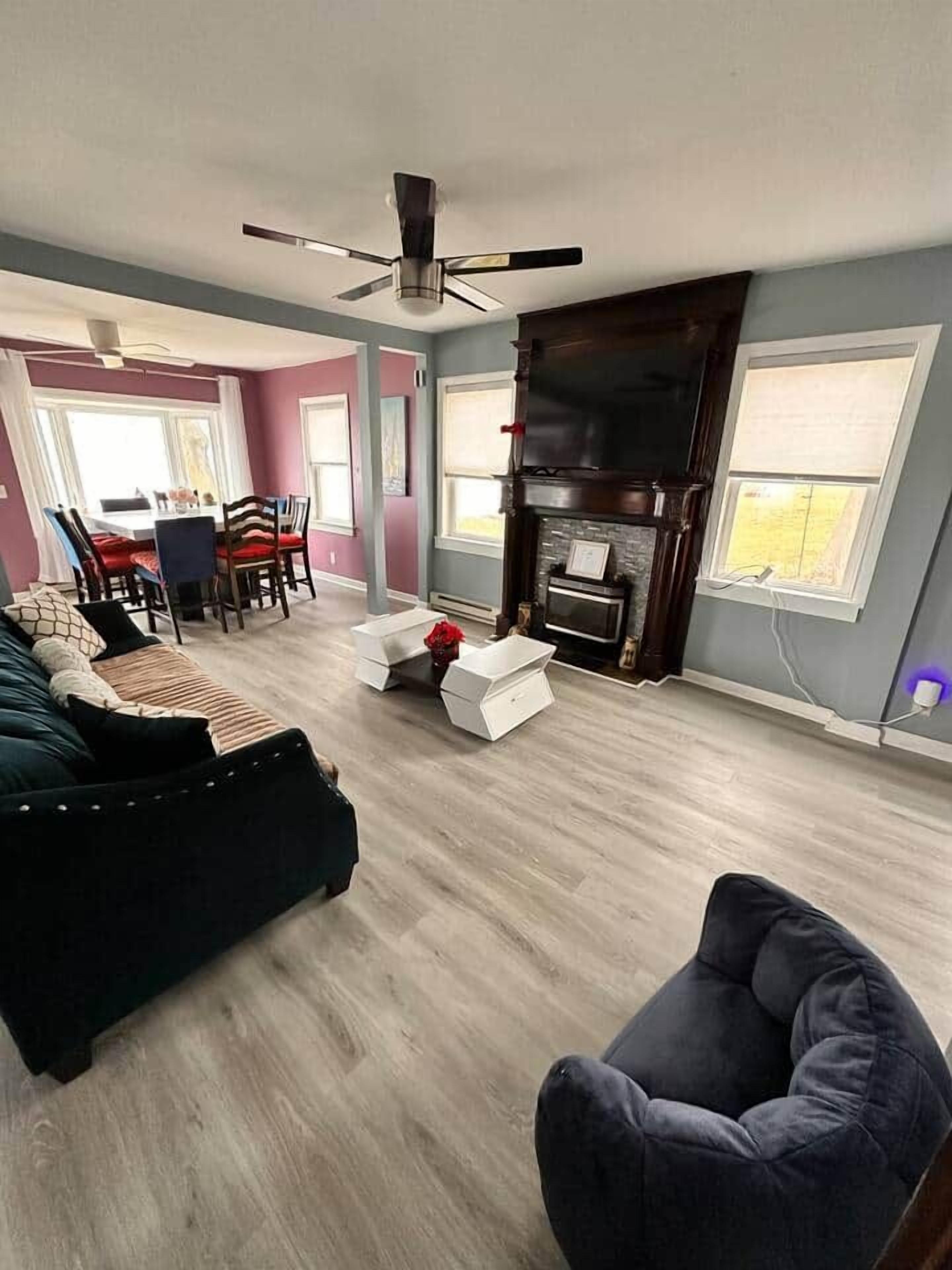 A living room with a dark-colored sofa, a white coffee table, and a fireplace.