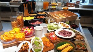 A buffet with a variety of dishes including fruits, vegetables, meats, and cheeses. - SK HOTEL KOBE STATION FRONT (Kobe)