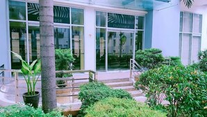 A building with 'Clubhouse' signage, a staircase leading to the entrance, and surrounding greenery. - One Palm Tree Villas - Unit 3i and 3j (Pasay)