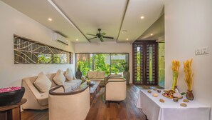 A spacious living area with a sofa set, a coffee table, and a decorative table with natural elements. - Siemreap Vasinh Residence (Siem Reap)