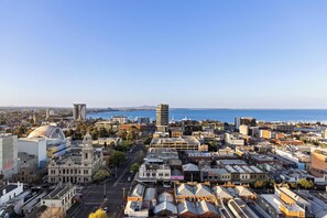 A cityscape with a prominent clock tower, a waterfront, and various buildings. - Quest Geelong Central (Geelong)