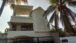 A two-story building with a balcony and a gated entrance. - Mi Casa (Guwahati)