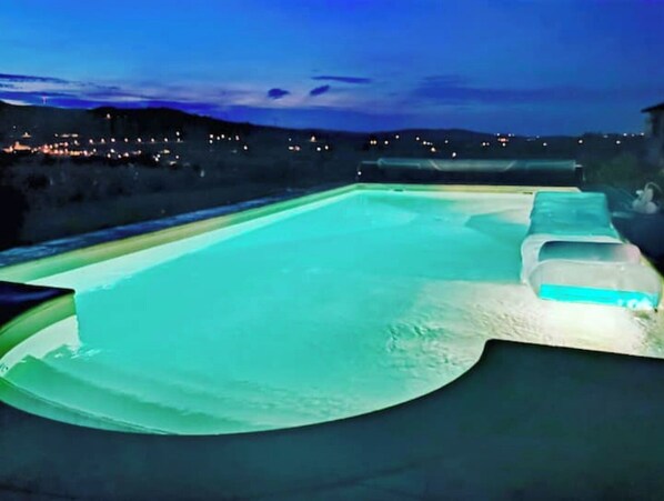 Relax by the pool surrounded by serene views of the surrounding landscape.