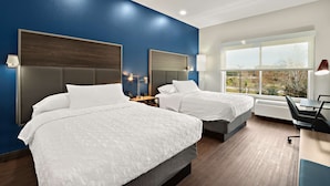 A hotel room with two beds, a desk, and a large window with a view. - Tru By Hilton Santee (Santee)