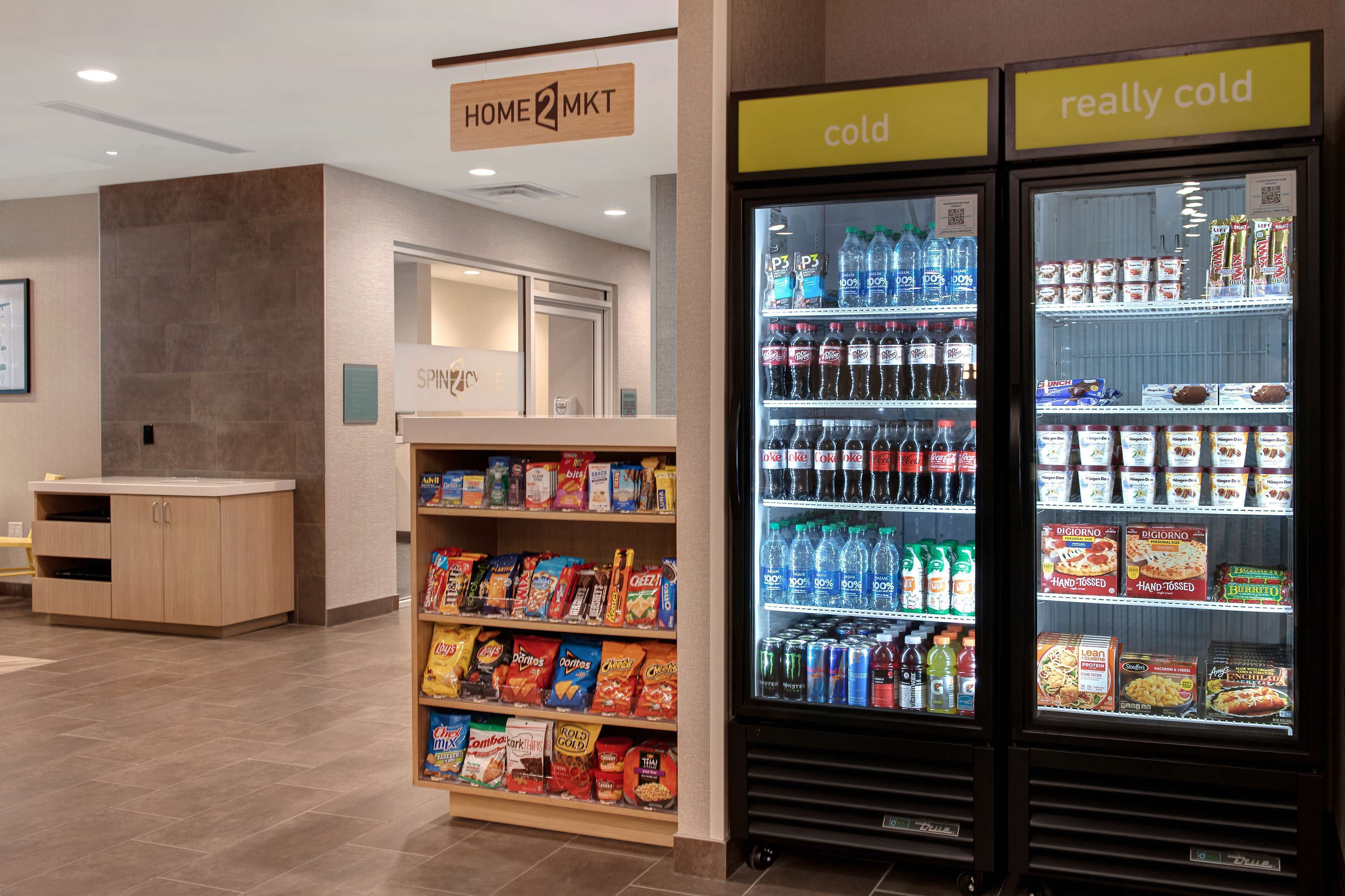 A snack and beverage vending area with a variety of snacks and drinks, including chips, cereals, and bottled water.