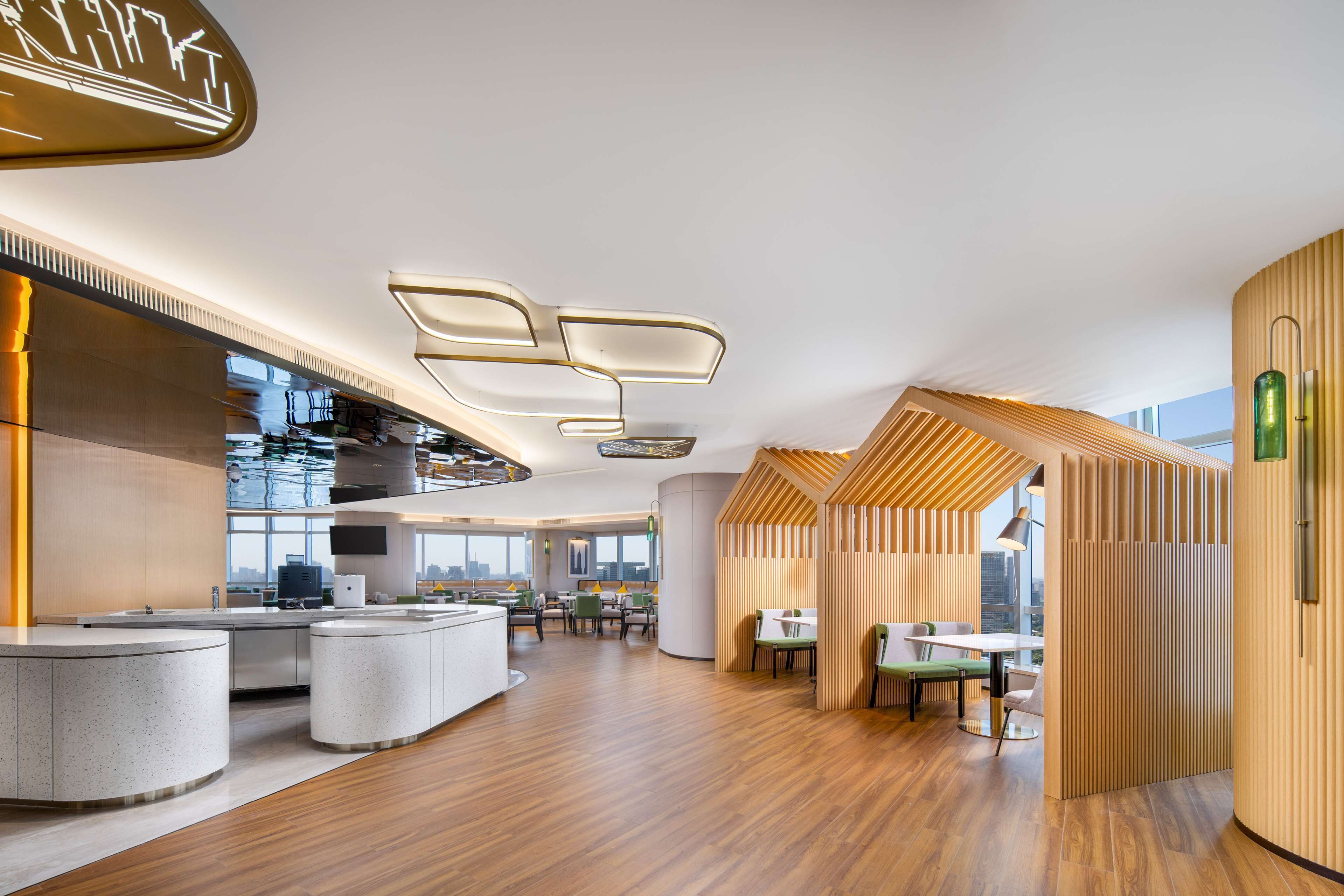 A modern interior with a kitchen area, dining space, and seating arrangements.