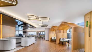 A modern interior with a kitchen area, dining space, and seating arrangements.