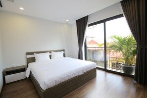 A modern bedroom with a large bed, a nightstand, a potted plant, and a view of the outside through a large window. - Sumitomo 9 Apartments - Alley 58 Dao Tan (Hanoi)