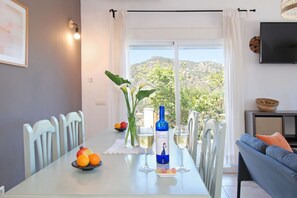 Enjoy a meal for two in this serene space, featuring a glass-top table and a flat-screen TV.