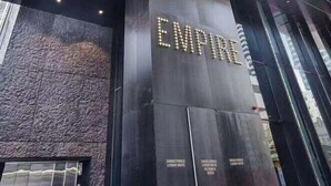A modern building with a prominent sign reading "EMPIRE". - Readyset Apartments at Empire (Melbourne)