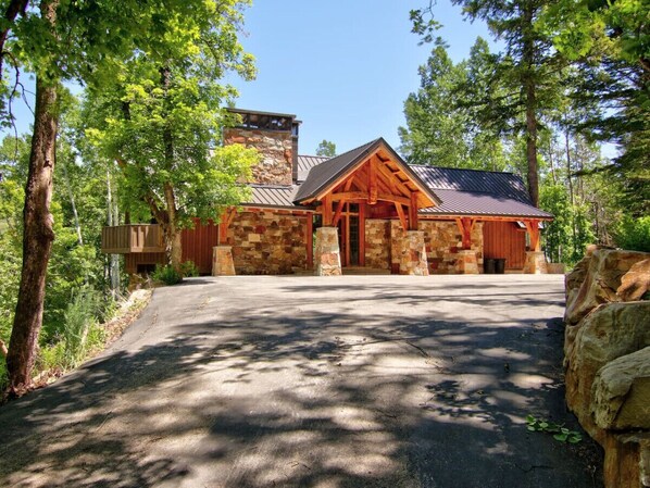 A lodge with a stone facade, wooden beams, and a metal roof. - Spacious mountain retreat • Built for gathering • Hot tub • Quiet setting • Minutes up Sundance Canyon (Sundance)