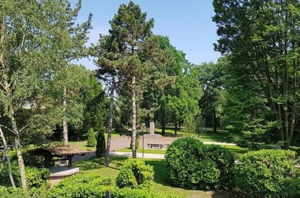 A park with a gazebo, benches, and well-maintained greenery.