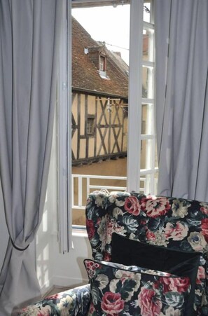 Enjoy a view of the traditional half-timbered building from the comfort of this room.