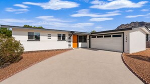 A single-story house with a garage, a front door, and a driveway. - Mountain Views | Hiking & Adventure (Phoenix)