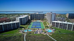 Enjoy breathtaking views of the water from this hotel's rooftop pool area, featuring a tennis court and multiple pools.