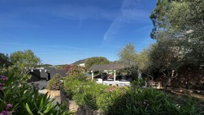 A garden area with a gazebo, stone walls, and various plants. - Lidia Capo Ceraso resort by Interhome (Porto Istana)