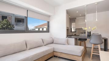 Deluxe Apartment | Living room | Flat-screen TV