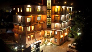 A multi-story building with balconies, large windows, and a central courtyard. - Royal Astoria Hotel (Burhanilkantha)