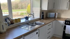 A modern kitchen with a sink, a kettle, a toaster, and cabinets. - Till Cottage 3 Fenton Hill Farm (Wooler)