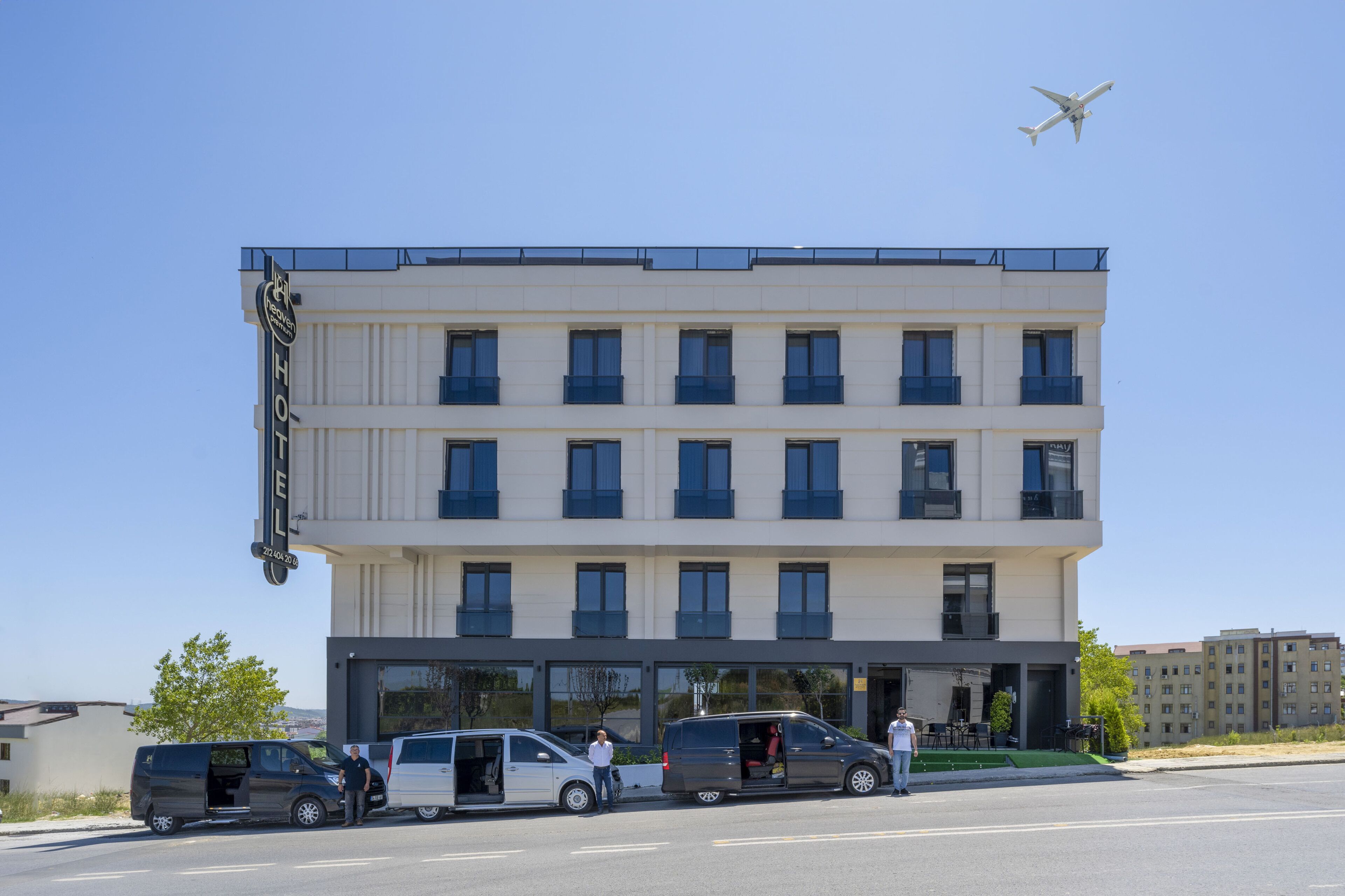 A hotel with multiple floors, a flat facade, and a sign indicating it is a hotel.