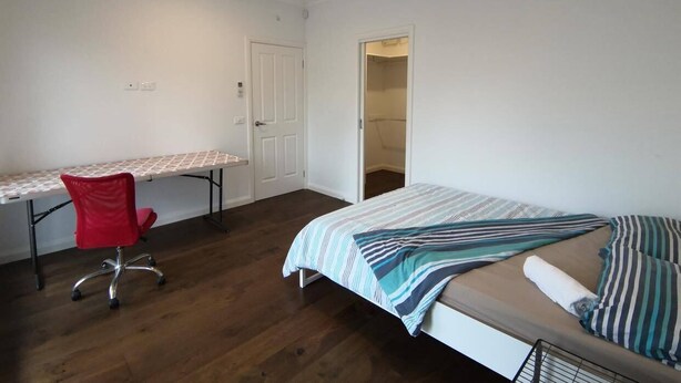 A bedroom with a bed, a desk, and a chair. - A Room located in Beautiful quiet court near The Glen (Glen Waverley)